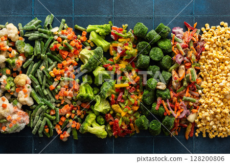 A vivid display of frozen fruits and vegetables in a colorful arrangement, illustrating the process of preserving healthy, seasonal produce for winter, promoting a healthy diet 128200806