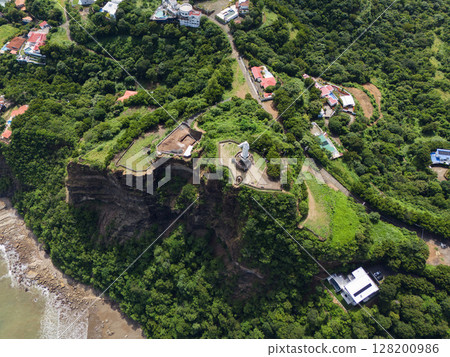 Green cliff with jesus christ statue 128200986