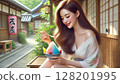 A young woman relaxing on the veranda of an old house and eating shaved ice 128201995