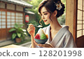 Beautiful woman in kimono eating shaved ice 128201998
