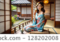 A young woman in a yukata relaxing in a Japanese-style room in an old house and eating ice cream 128202008