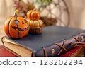 Halloween pumpkin, old notebook and old book 128202294