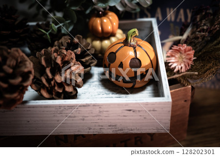 Halloween pumpkins and pine cones 128202301
