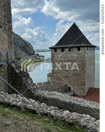 Golubac Fortress (Golubacka trvdjava, or Goluback Grad) taken during a sunny afternoon with windmills in background. The Golubac Castle was a medieval fortified town on the Danube River in Serbia Golubac Fortress (Golubacka trvdjava, or Goluback Grad) taken during a sunny afternoon with windmills in background. The Golubac Castle was a medieval fortified town on the Danube River in Serbia 128202623
