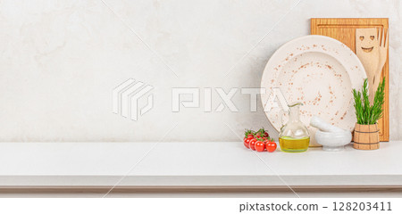 A rustic kitchen setup with fresh herbs, olive oil, cherry tomatoes, and ceramic dishes, cozy atmosphere for homemade Mediterranean cooking, copy space 128203411