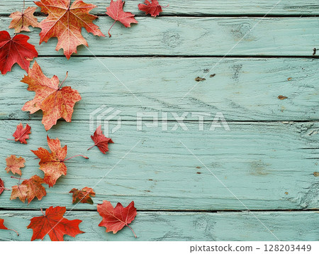 Distressed blue wooden background adorned with vibrant autumn maple leaves. 128203449