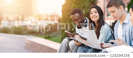 Happy Teens International Students Studying Together Outdoors, Enjoying University Life, Selective Focus On Asian Girl Happy Teens International Students Studying Together Outdoors, Enjoying University Life, Selective Focus On Asian Girl 128204256