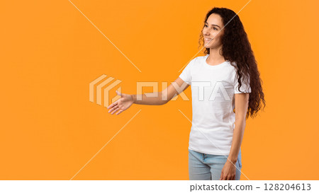 Hello. Side View Of Cheerful Woman Offering Hand For Handshake Greeting Aside Standing Posing Over Yellow Studio Background. Nice To Meet You. Lady Doing Shaking Hands Gesture. Panorama, Free Space 128204613