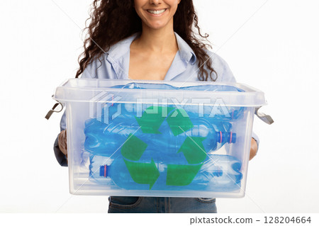 Plastic Recycling. Unrecognizable Lady Holding Container With Recycle Symbol Full Of Litter Rubbish Standing On White Studio Background. Waste Sorting And Junk Disposal. Cropped Plastic Recycling. Unrecognizable Lady Holding Container With Recycle Symbol Full Of Litter Rubbish Standing On White Studio Background. Waste Sorting And Junk Disposal. Cropped 128204664