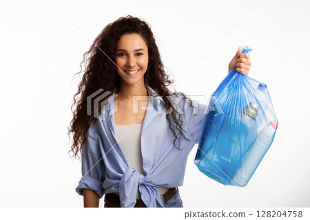 Smiling Woman Posing With Plastic Garbage Bag Showing Sorted Waste Standing Over White Studio Background. Keep Environment Clean And Sort Your Junk, Litter Disposal Concept 128204758