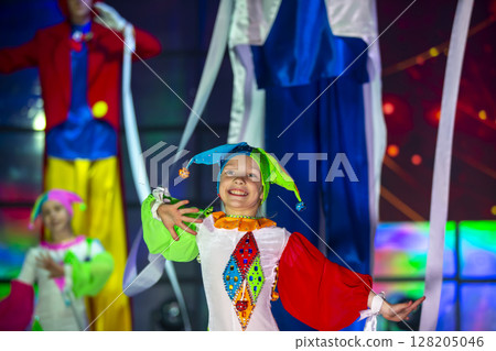 Little girl is dancing in a clown costume. The child performs on stage. Little girl is dancing in a clown costume. The child performs on stage. 128205046
