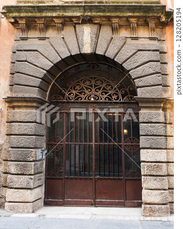 Old medieval front door at Verona, Italy. Old medieval front door at Verona, Italy. 128205194