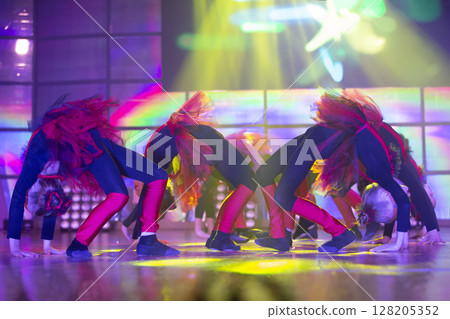 Little girls perform a dance number. Dance for helovinna in red costumes.Little girl dancing 128205352
