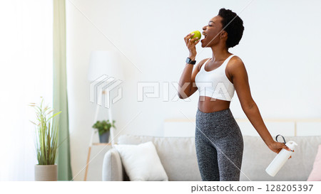 Weight Loss. Cheerful Black Lady Weighing Standing On Scales Posing Holding Apple And Water Bottle At Home. Successful Slimming And Healthy Dieting Nutrition Concept. Full Length, Empty Space Weight Loss. Cheerful Black Lady Weighing Standing On Scales Posing Holding Apple And Water Bottle At Home. Successful Slimming And Healthy Dieting Nutrition Concept. Full Length, Empty Space 128205397