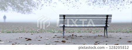 Empty wooden bench in a foggy park surrounded by fallen leaves, evoking feelings of solitude and reflection Empty wooden bench in a foggy park surrounded by fallen leaves, evoking feelings of solitude and reflection 128205812