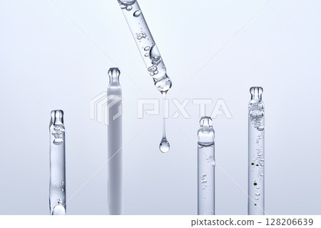 Five different droppers with facial serum in a row. 128206639