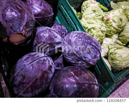 Fresh purple and green cabbages arranged in baskets showcasing vibrant colors and textures in a market setting promoting healthy eating concept 128206857
