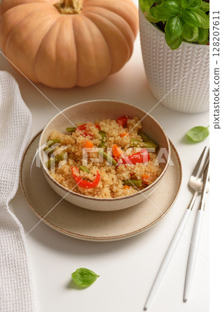 Quinoa vegetable salad on white wooden table. Vegetarian and diet food 128207611