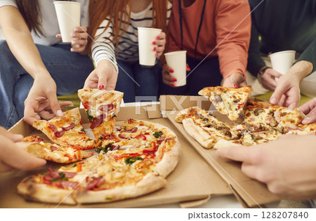 Young people friends gathering in pizzeria or at home eating pizza slices enjoying party. Young people friends gathering in pizzeria or at home eating pizza slices enjoying party. 128207840