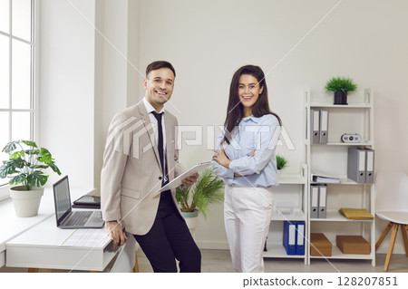 Happy colleagues meet in office room chatting enjoy friendly conversation, smiling business mates 128207851
