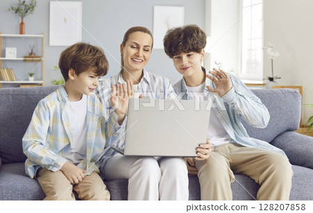 Happy Mother With Two Sons Having Online Video Call On Laptop At Home 128207858
