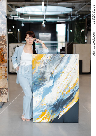Artist Standing Next to Abstract Painting in Modern Gallery Artist Standing Next to Abstract Painting in Modern Gallery 128208118