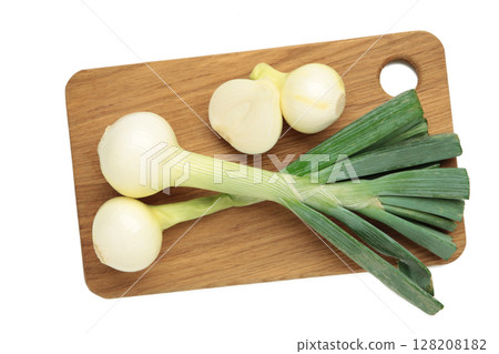 Green onion on cutting board isolated on white background. Green onion on cutting board isolated on white background. 128208182