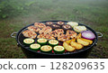 Grill with chicken vegetables. Barbecue food prepared outdoor cookout. Summer picnic party healthy eating. Close-up realistic style blurred background 128209635