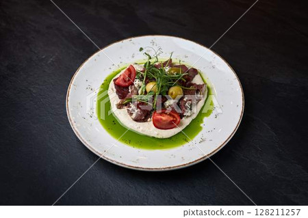 Gourmet beef tartare with creamy hummus base Gourmet beef tartare with creamy hummus base 128211257