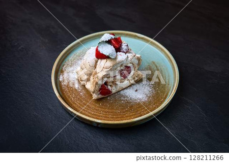Strawberry meringue roulade with whipped cream 128211266
