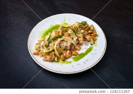Tagliatelle pasta with chicken and herb sauce Tagliatelle pasta with chicken and herb sauce 128211267
