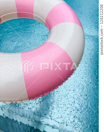 Swimming ring with pink and white stripes in a blue outdoor pool. Poolside atmosphere. Pink float. 128212206