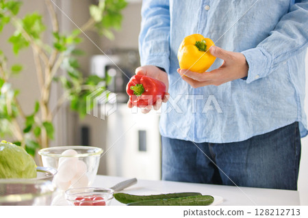 一個年輕人切蔬菜的手 一個年輕人切蔬菜的手 128212713