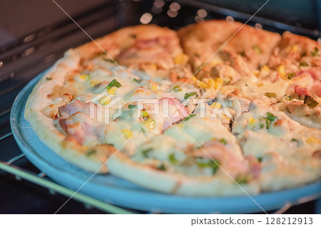 Pizza in a ceramic plate for serving. 128212913