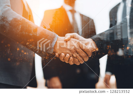 Business Professionals Engaging in Handshake During Conference in Urban Office Setting 128213552