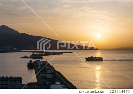 View of a ferry at sunset entering the port of Ceuta 128214473
