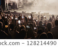 Audience holding up cell phones to record event 128214490