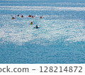 People paddling a canoe on the sea 128214872