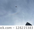 An airplane crossing the circumzenith arc in the sky above Nishi-Shinjuku, Tokyo 128215383