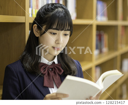 High school girls reading books in the library | Quiet learning moments 128215417