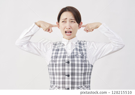 Female office worker covering her ears white background Female office worker covering her ears white background 128215510