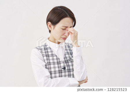 Female office worker eyestrain white background Female office worker eyestrain white background 128215523