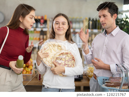 Parents scold happy girl with pizza at grocery store Parents scold happy girl with pizza at grocery store 128215767