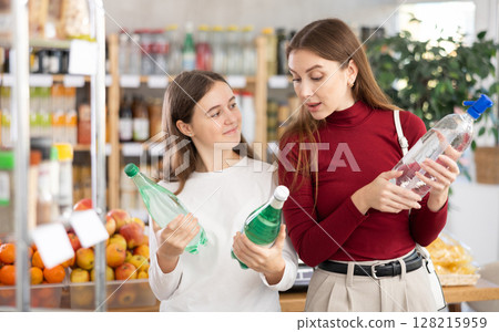 Mother and daughter choose soda 128215959