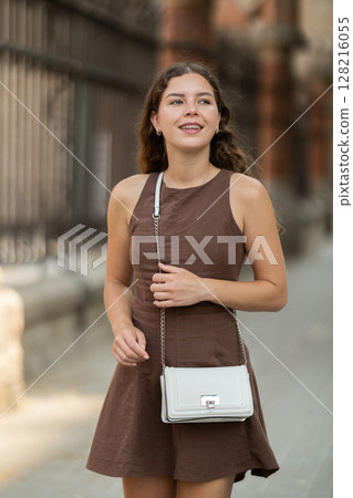 woman stands in front of a fence in Barcelona 128216055