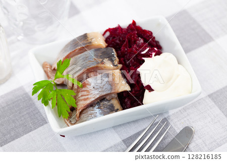 Traditional herring salad with beetroot and parsley in white plate Traditional herring salad with beetroot and parsley in white plate 128216185
