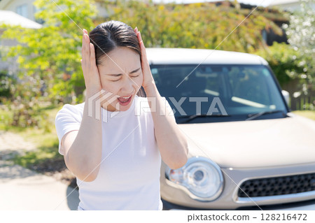 女人把頭靠在她的車旁邊 128216472