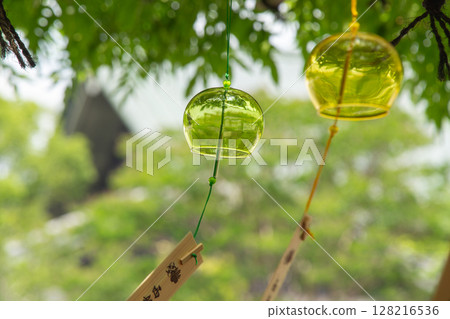 Wind chimes swaying in the wind Wind chimes swaying in the wind 128216536