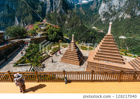 Tibetan Stupa with Prayer Flags and Snowy Peaks in Balagezong, Shangri-La, Yunnan. 128217040