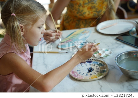 A young mother and her daughter enjoy a creative art session at home A young mother and her daughter enjoy a creative art session at home 128217243